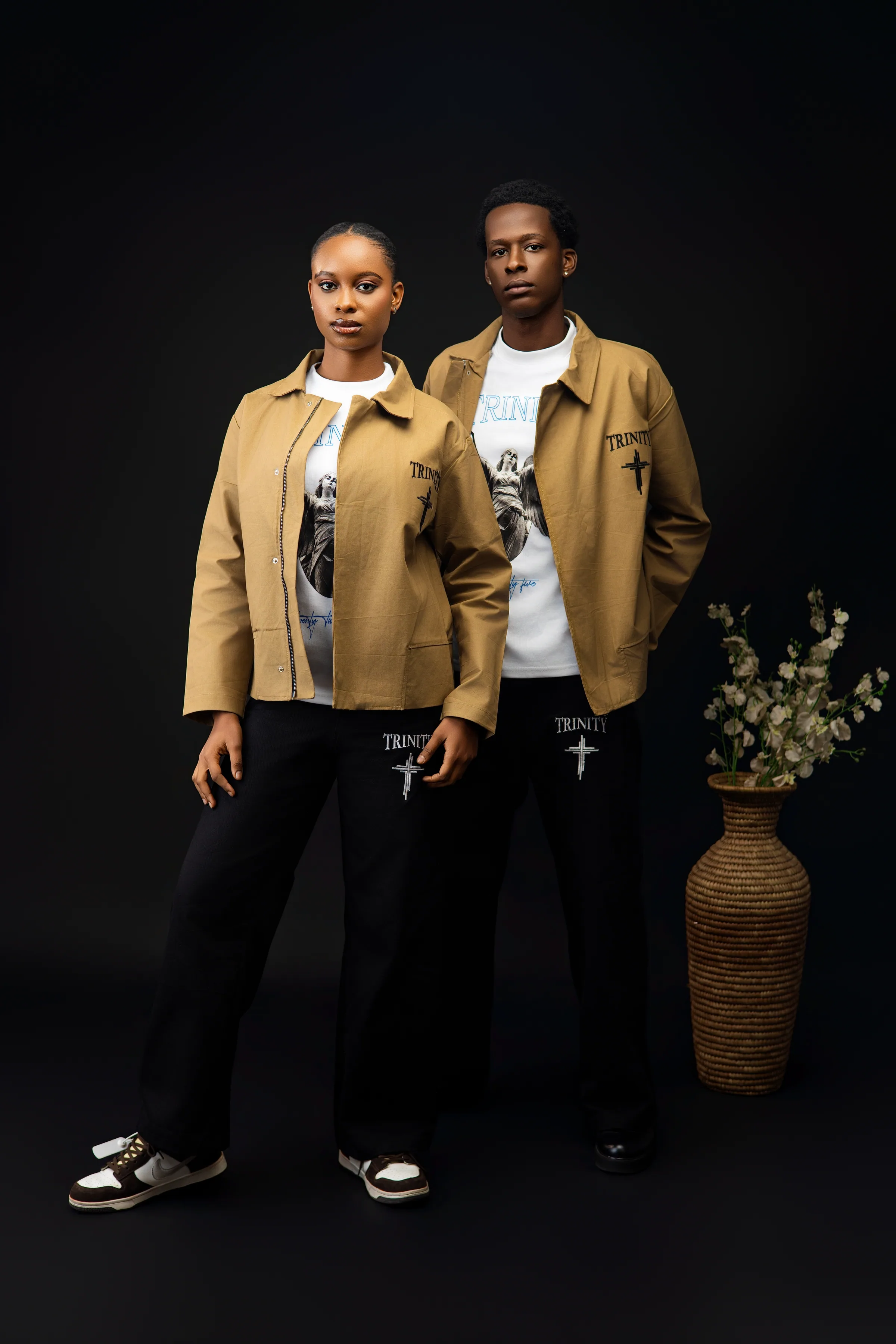 Both models standing together in full length, wearing the relaunch collection